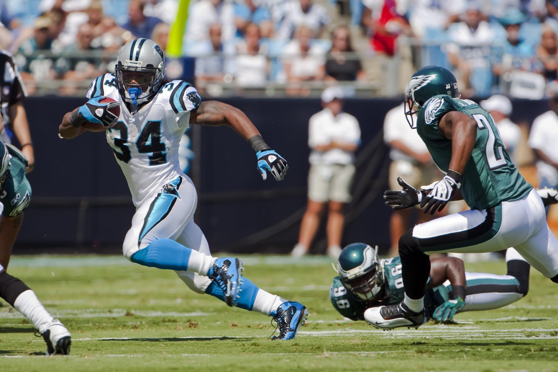 The running back player runs against the other team
